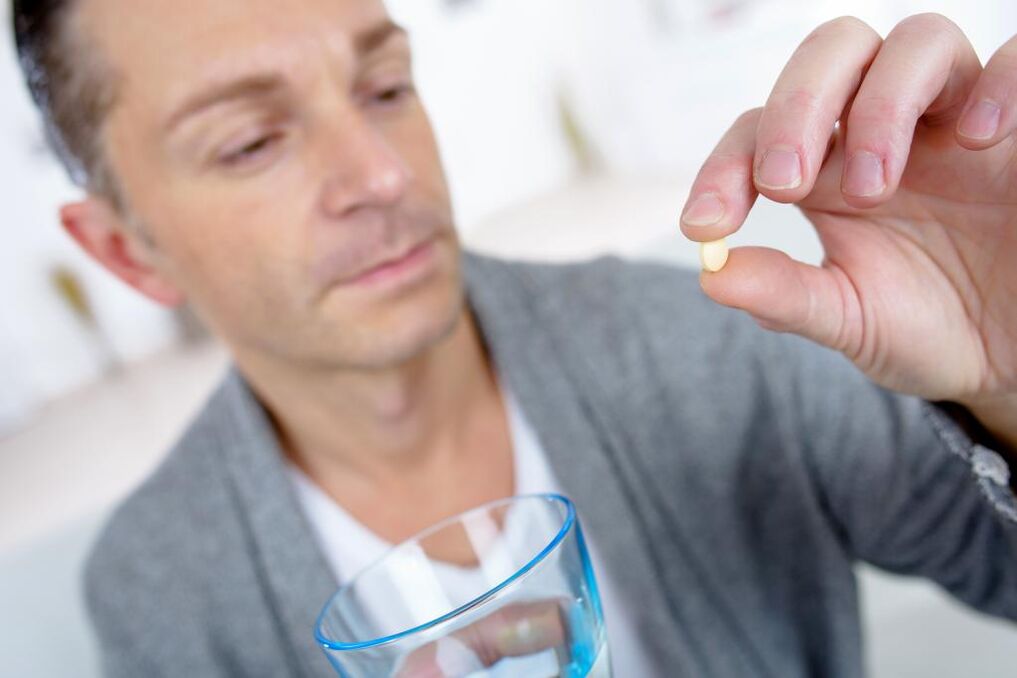 A man drinks pills to increase effectiveness